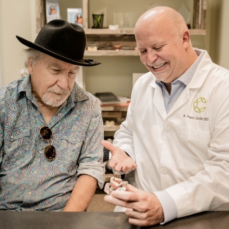 Doctor Cordini talking to periodontal patient