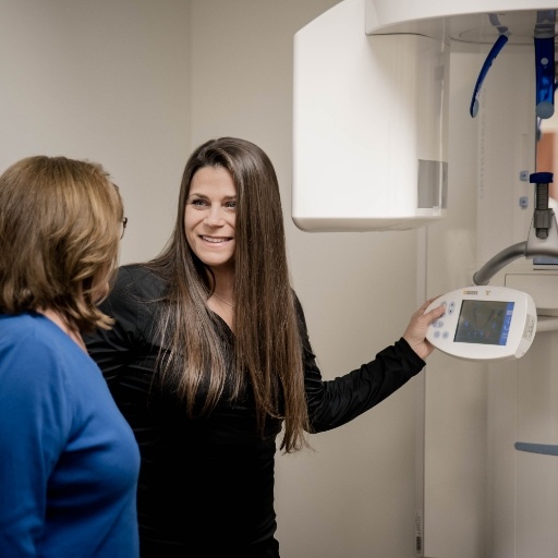 Dentist looking at digital x-rays on computer screen