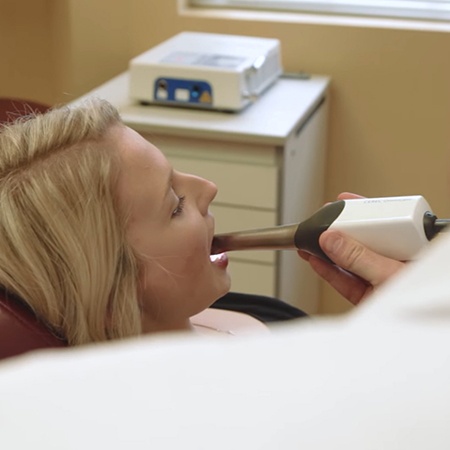 Dentist using an intraoral camera to capture smile images