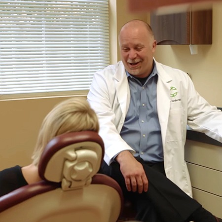 Periodontist talking to patient