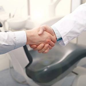 Emergency dentist in Louisville shaking hands with a patient
