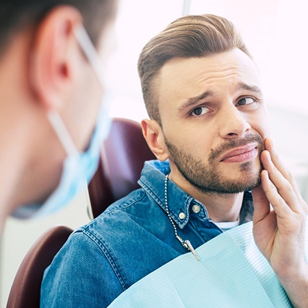 Patient with toothache looking at dentist