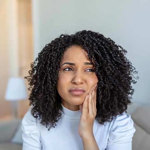Woman experiencing toothache at home