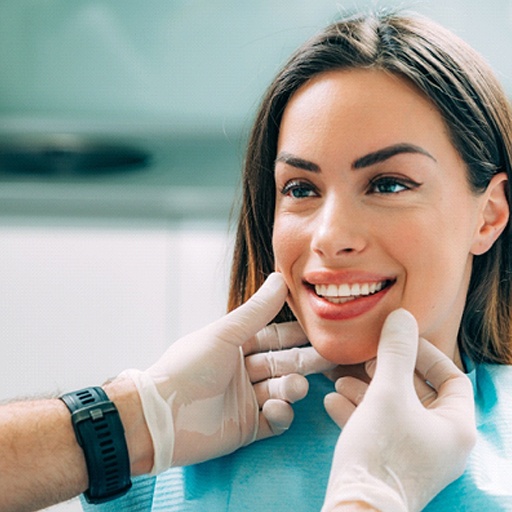 Periodontist in Louisville examining a patient’s smile