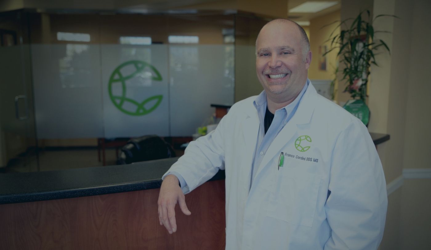 Louisville Kentucky periodontist Doctor Franco Cordini smiling in periodontist office