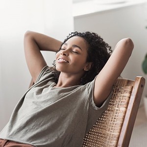 a woman sitting back and relaxing after a dental visit