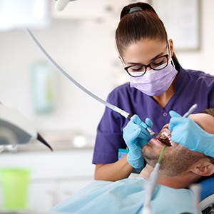 a dentist cleaning a patient’s teeth