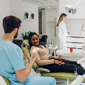 a dentist collecting a patient’s medical history