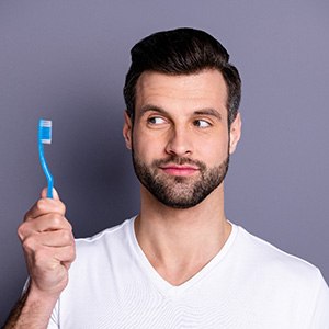 a man holding a toothbrush