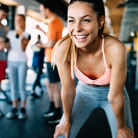 Healthy woman smiling at the gym