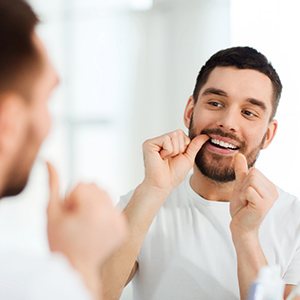 A man flossing his teeth