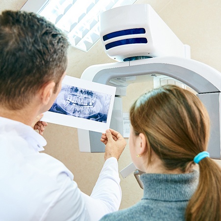 Dentist showing female patient their dental X-ray