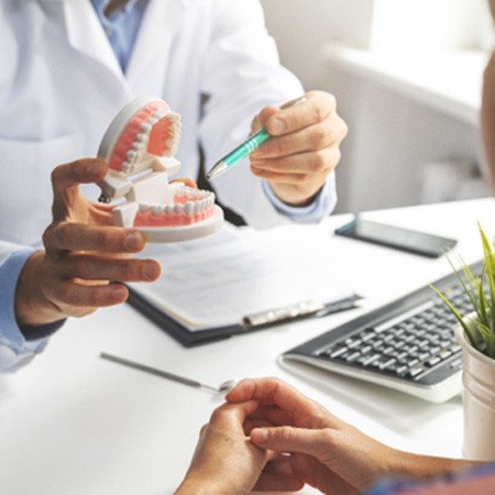 A dentist talking to a patient about full mouth reconstruction