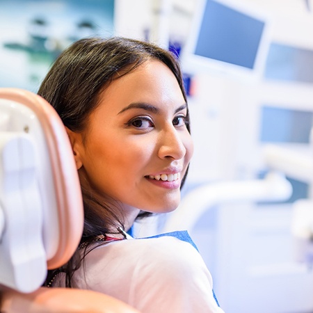 Female patient leaning back in chair and smiling