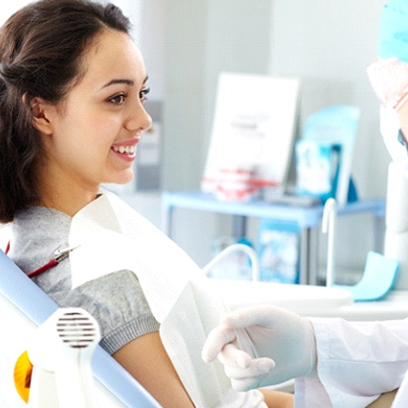 Woman smiling at her sedation dentist in Louisville