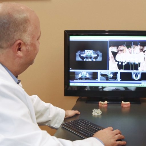 Periodontis reviewing digital x-rays on chairside computer