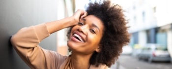 Woman showing off beautiful smile after cosmetic periodontics