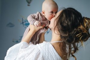 Woman kissing a baby 