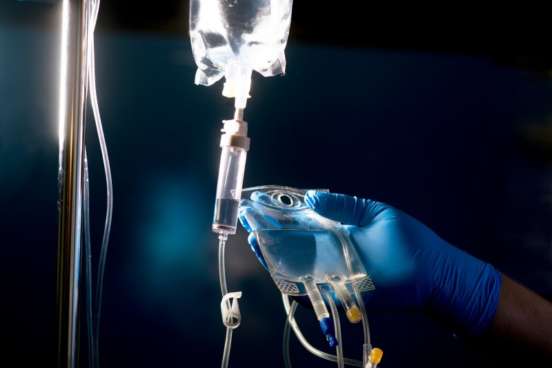 A dentist preparing an iv sedation drip