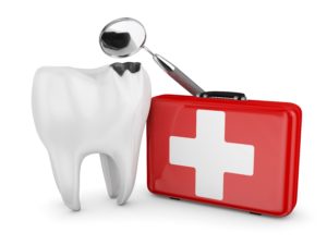 A damaged tooth next to a red emergency kit and a dental mirror